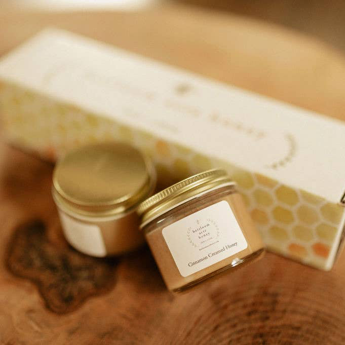 A jar of creamed honey sits in front of a gift box with a label that reads 'Salted Honey'. The box contains more bucks county local honey in a sample size gift set.