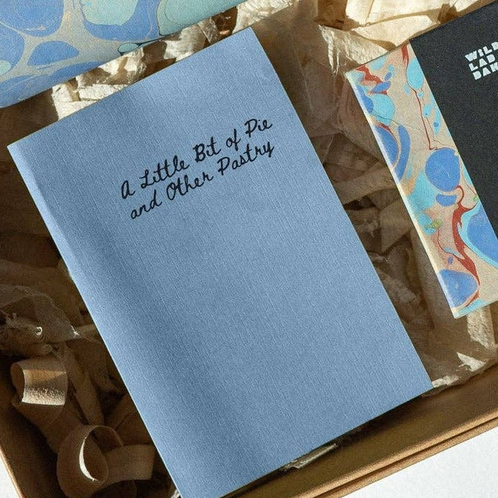 Open cardboard box containing a set of blue and black items on a light background