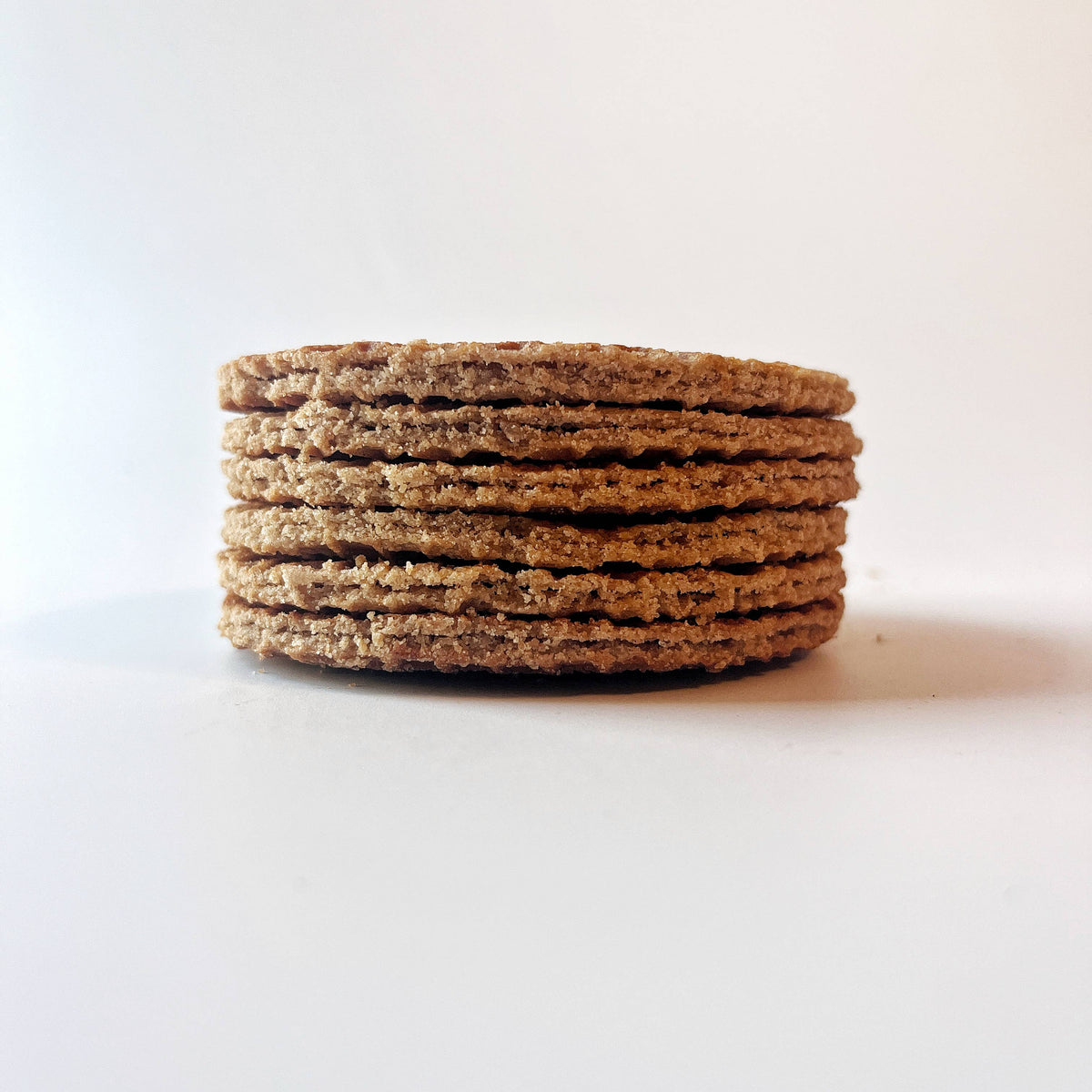 Stack of brown cookies on a white background