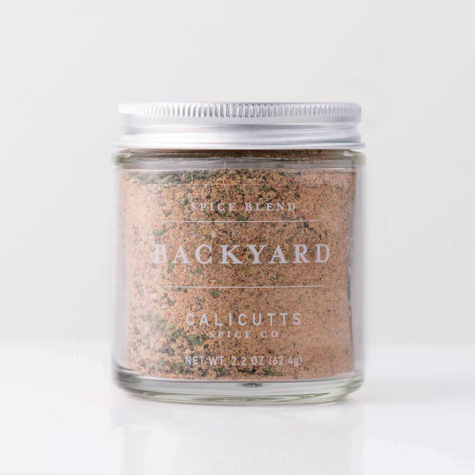 Clear glass jar of Backyard Spice Blend with silver metal lid, artisan handmade seasoning, perfect unique gift. - Backyard Spice Blend