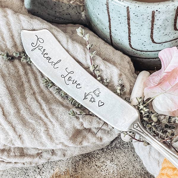 Handmade ceramic butter spreader with "Spread Love" script and heart detail, unique artisan gift. - Spread Love Spreader