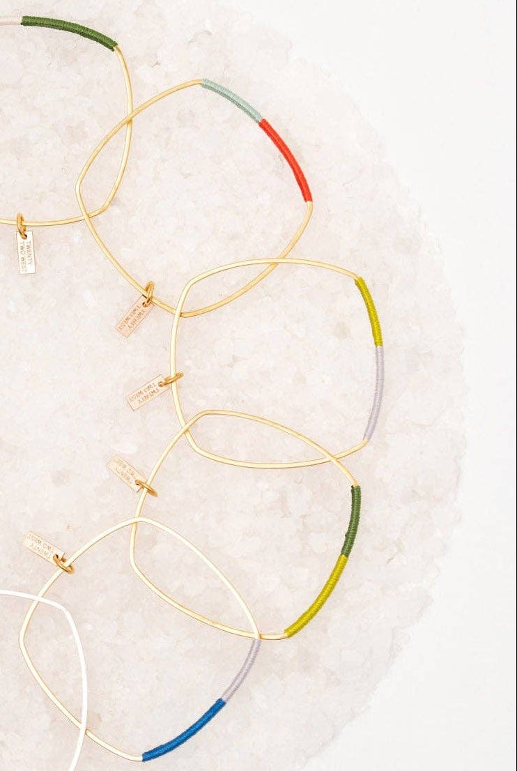 Set of colorful bangle bracelets on a white background
