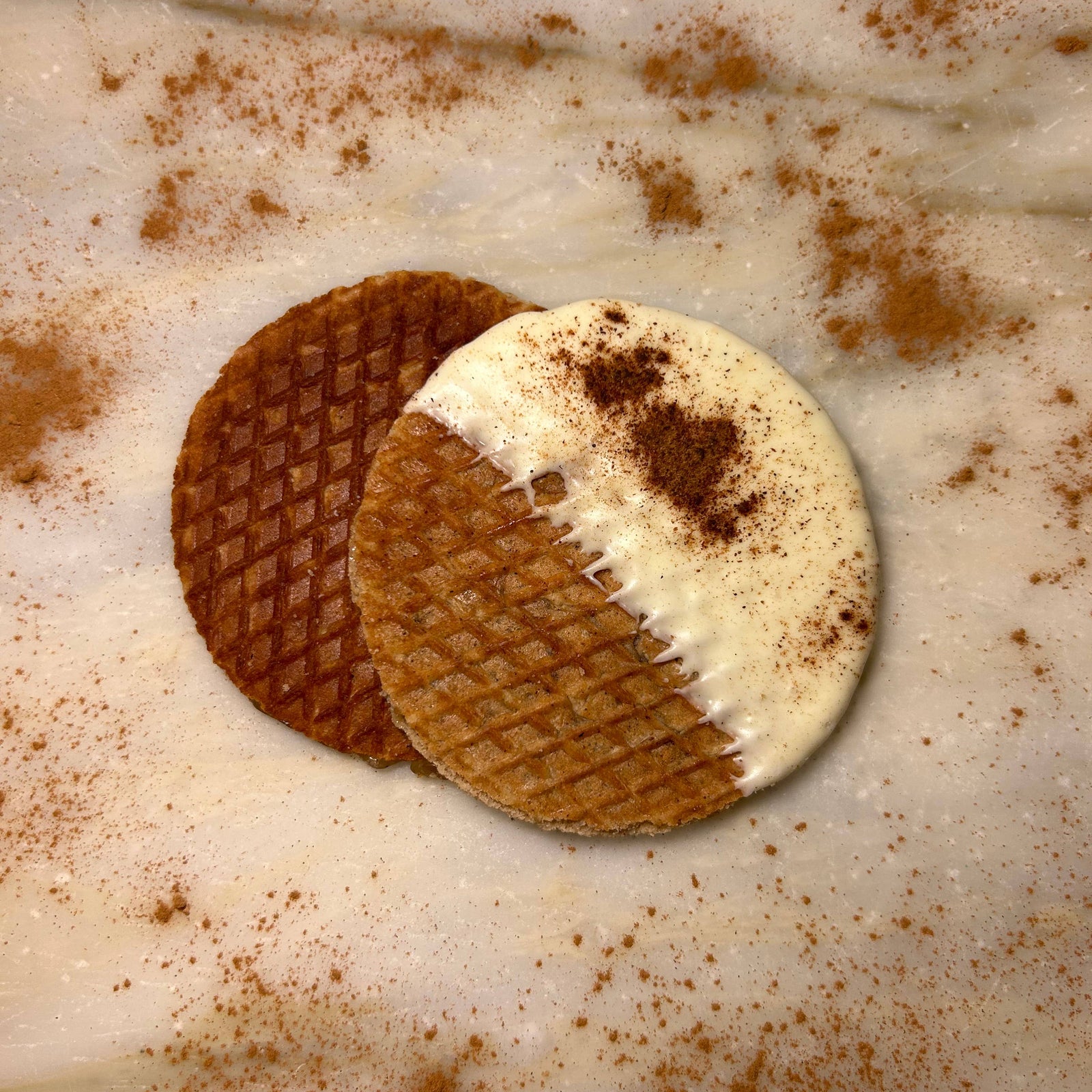 Two artisan pumpkin spice stroopwafels, one dipped in white chocolate with cinnamon dusting, handmade gift quality. - Pumpkin Spice Stroopwafels Gift Pack (6)