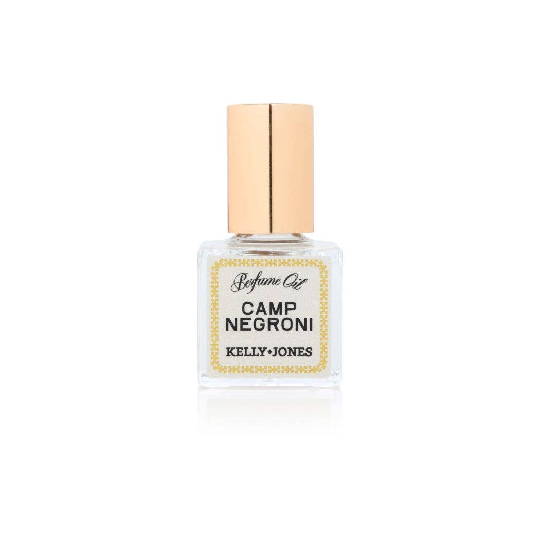 Handmade SUPPER CLUB Camp Negroni perfume oil in a clear glass bottle with a gold cap, unique gift item. - SUPPER CLUB Perfume Oil: Camp Negroni