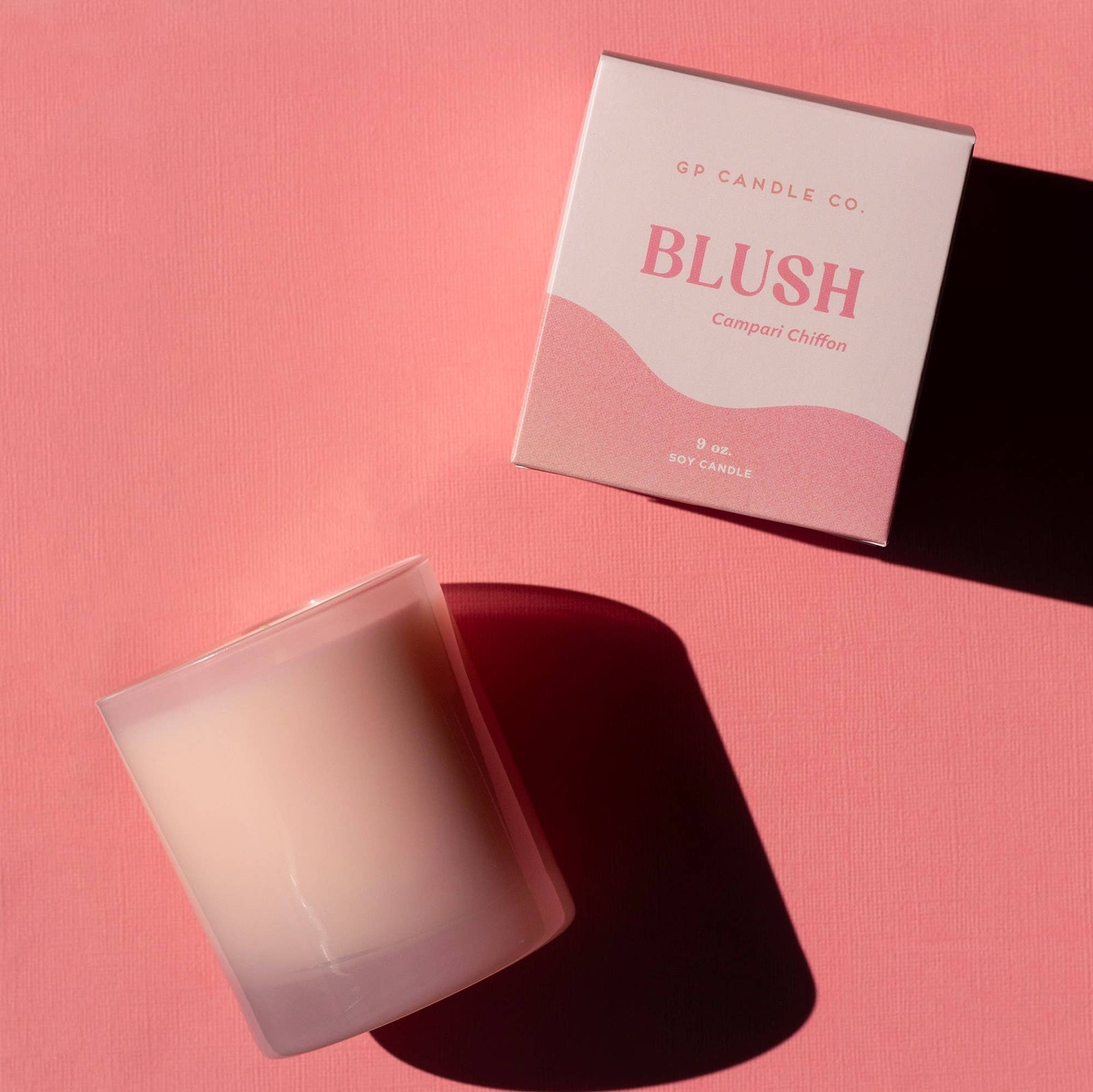 Handmade blush pink candle in frosted glass with matching Campari Chiffon gift box on pink background. - Blush 9 oz. Hue Candle (Campari Chiffon)