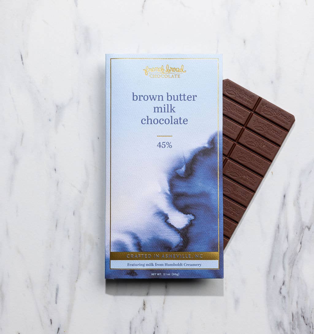 Brown butter milk chocolate bar with packaging on a marble surface