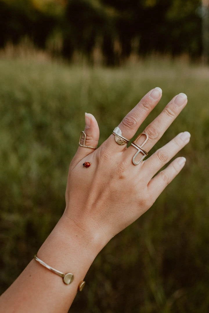 Handmade brass dot dash dash rings on slender fingers, artisan design perfect as a special gift. - Brass Dot Dash Dash Ring