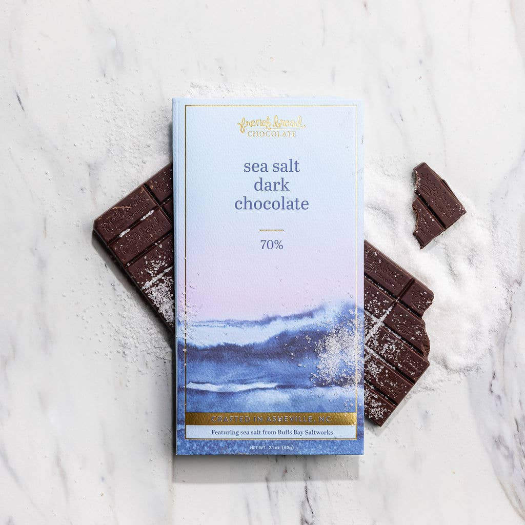 Sea salt dark chocolate bar with packaging on a marble surface
