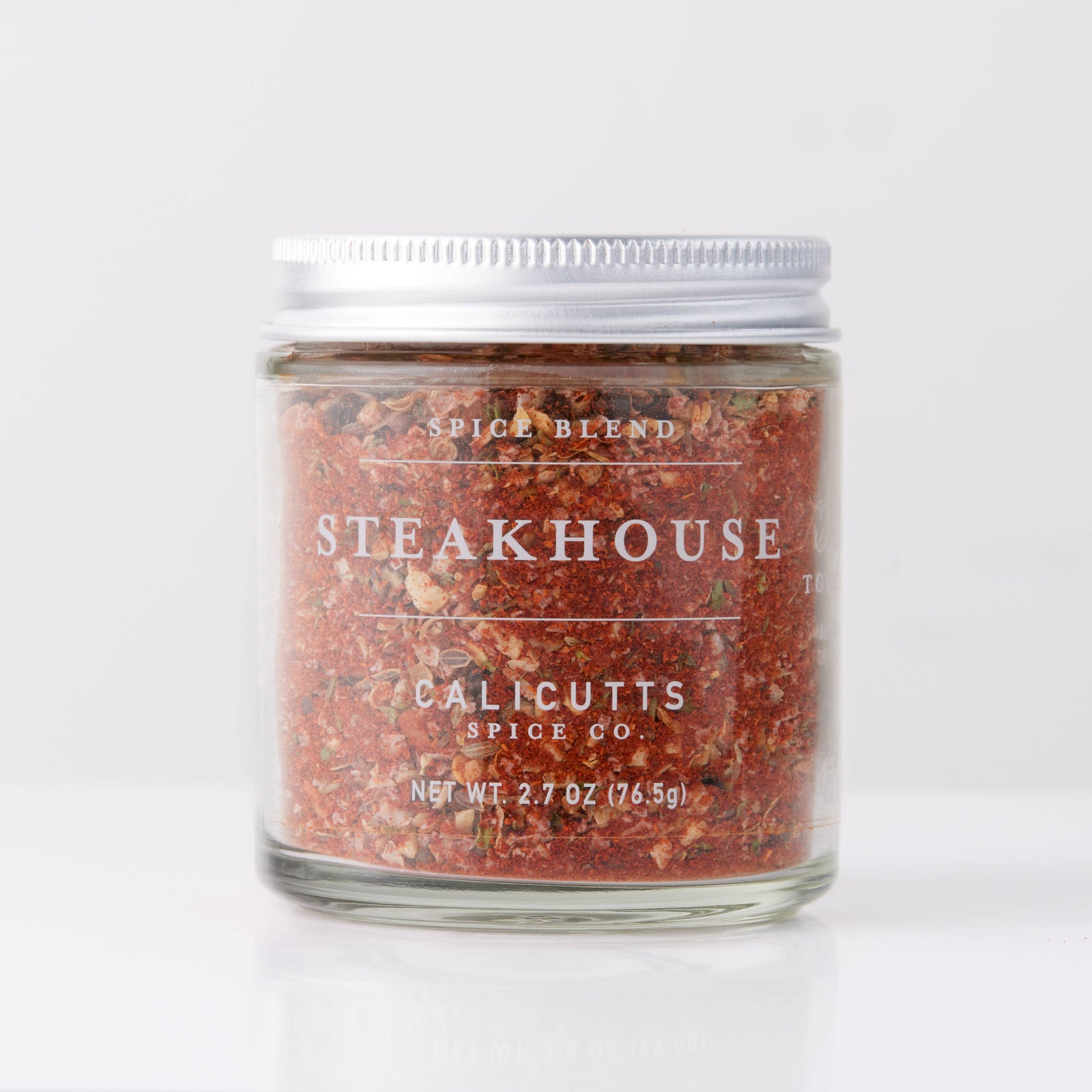 Handmade artisan steakhouse spice blend in a clear glass jar with white lid, perfect unique gift. - Steakhouse Spice Blend