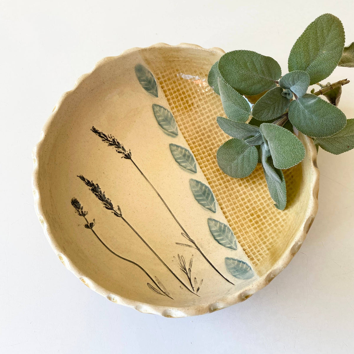 Ceramic bowl with botanical design on a white background