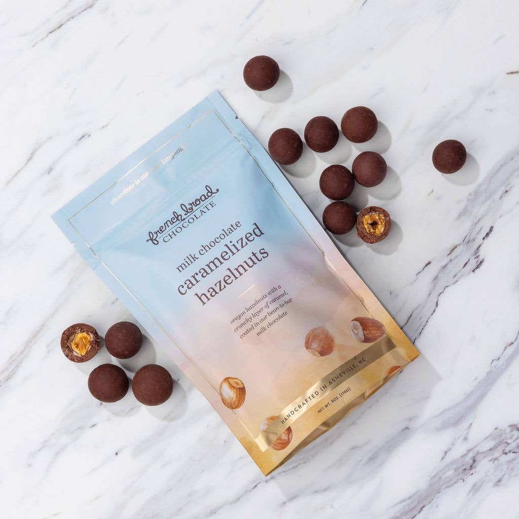 Packaging of milk chocolate caramelized hazelnuts on a marble surface