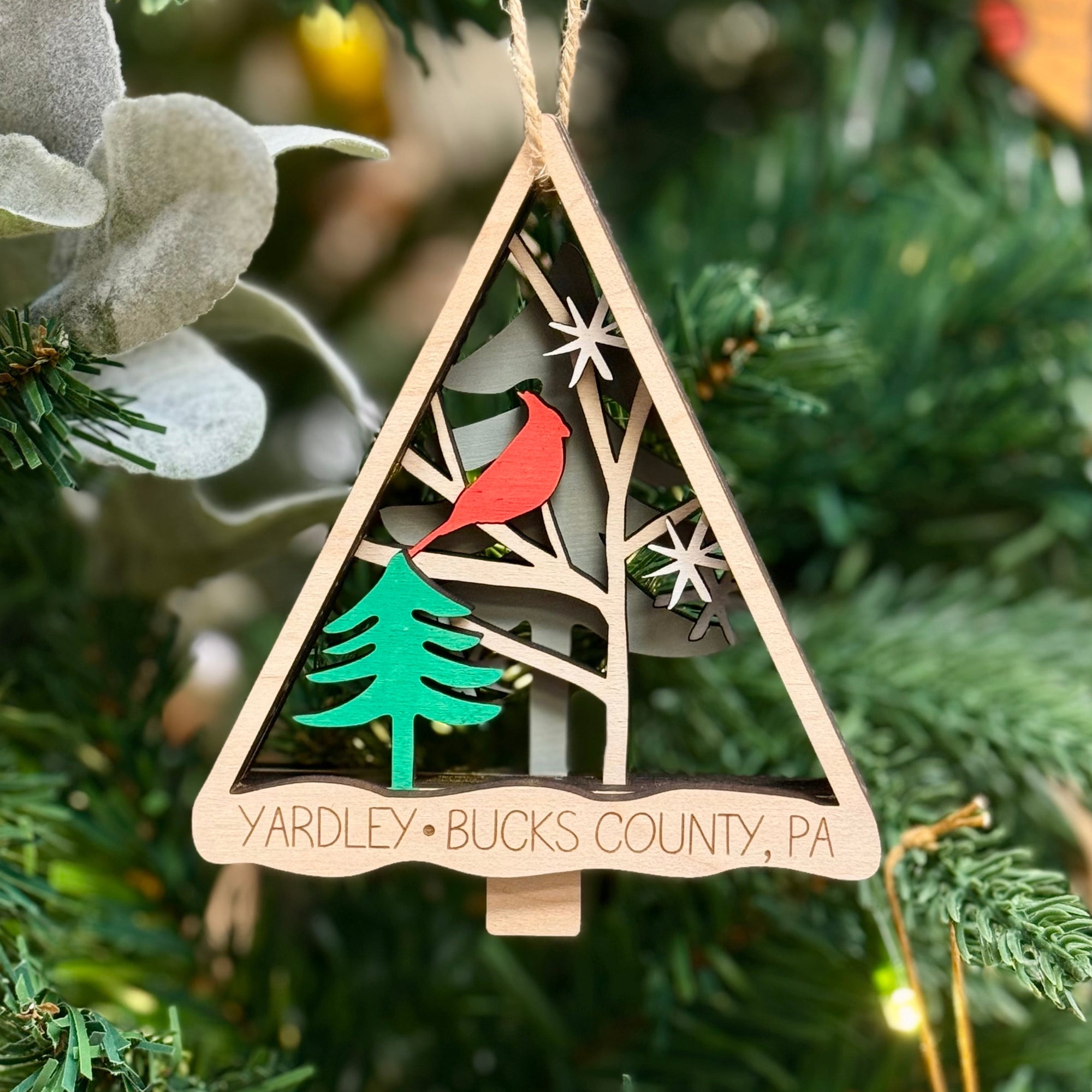 Yardley Bucks County wooden  Christmas ornament featuring a cardinal sitting in a festive tree