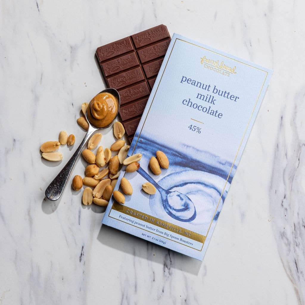 Peanut butter milk chocolate bar with packaging on a marble surface