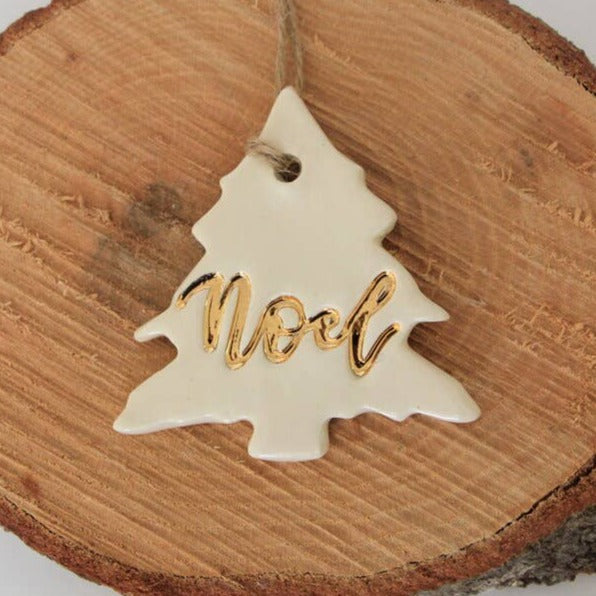 white ceramic christmas ornament with word noel